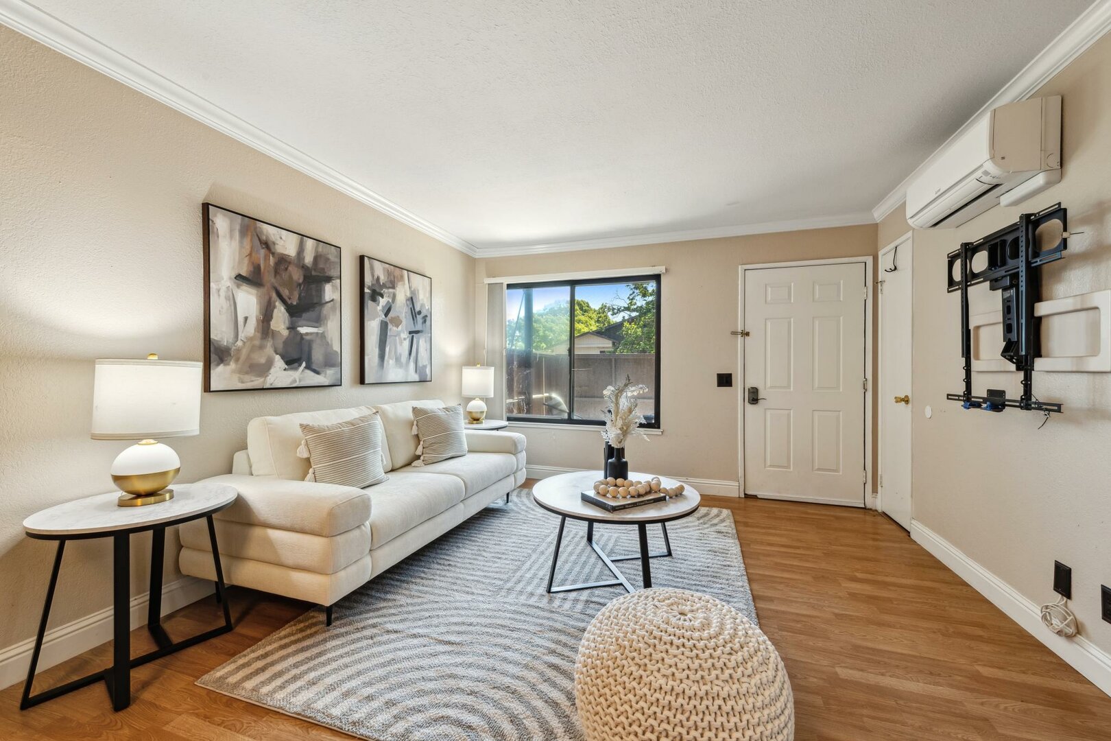 Bright living room with sofa, coffee table, and entry door
