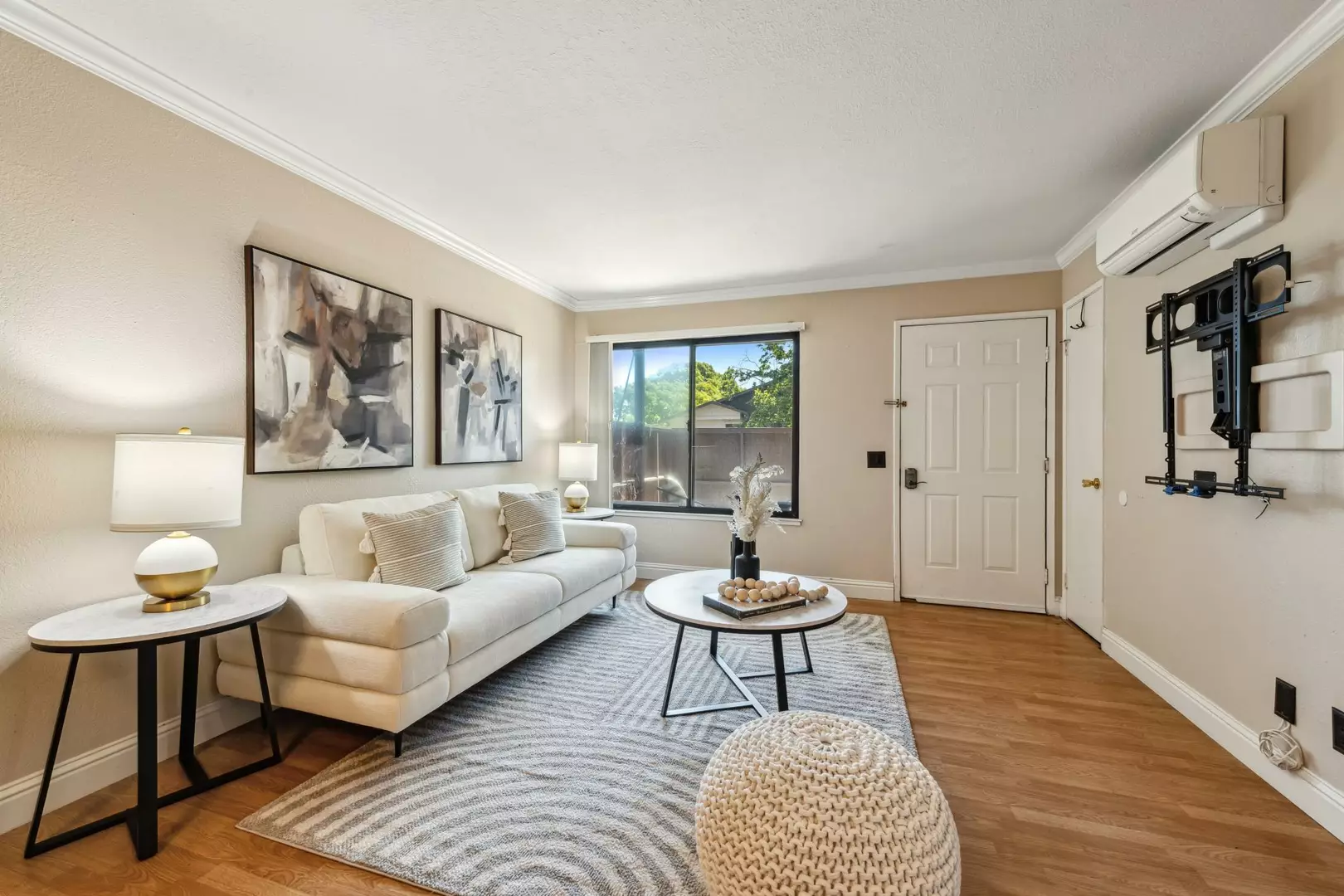 Bright living room with sofa, coffee table, and entry door