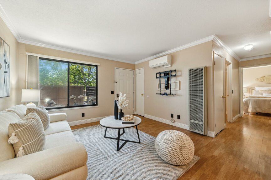 Bright living room with sofa, coffee table, and large window