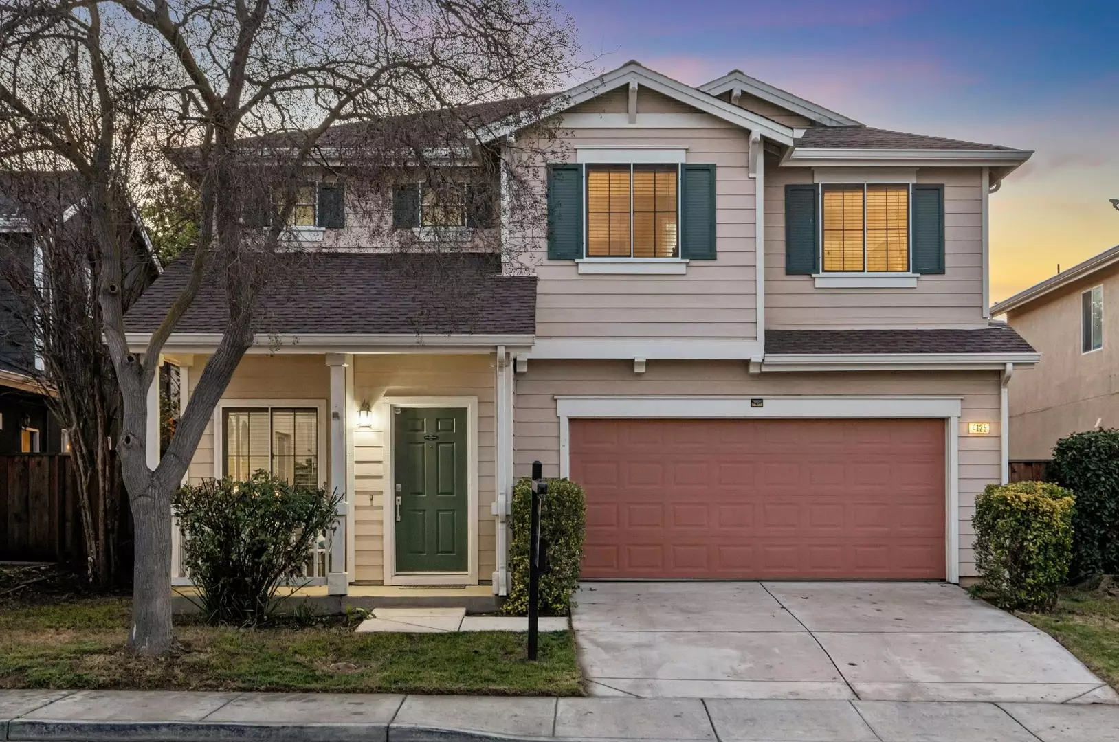Front exterior of a two-story house with driveway and attached garage