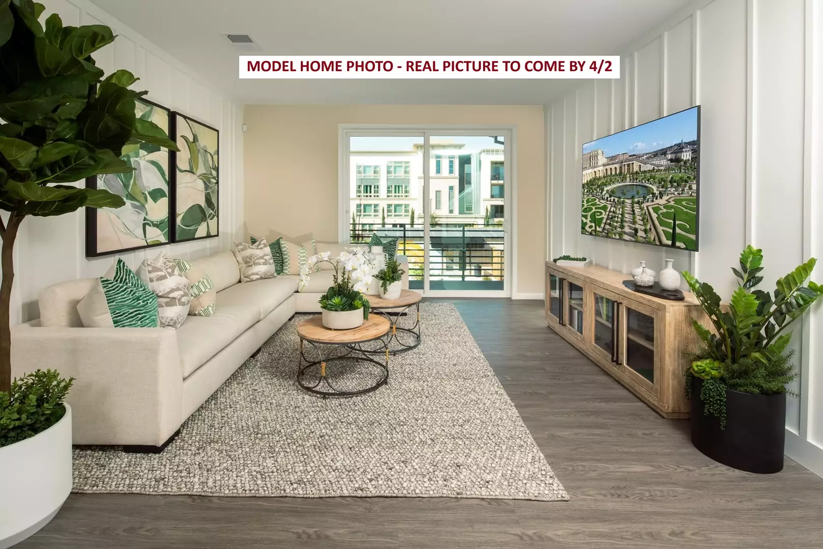 Bright modern living room with sofa, coffee tables and wall-mounted TV